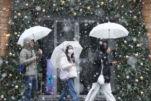 눈이 내리는 30일 오전 서울 중구 명동 거리에서 관광객들이 눈을 맞으며 걷고 있다./뉴스1