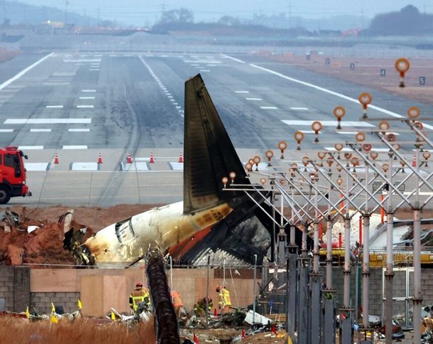 지난 12월30일 전남 무안군 무안국제공항 활주로에 전날 동체 착륙을 시도하다 남긴 스키드 마크가 제주항공 여객기 너머로 보이고 있다. 김혜윤 기자 unique@hani.co.kr