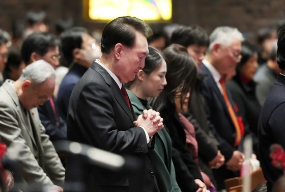 윤석열 대통령이 25일 오전 서울 중구 정동제일교회에서 열린 성탄 예배에서 기도하고 있다. 윤 대통령은 전날 혜화동성당에서 열린 성탄 미사도 참석했다. 김건희 여사는 이틀 모두 동행하지 않았다. 김 여사는 네덜란드 국빈 방문 이후 공개석상에 모습을 보이지 않고 있다. [사진 대통령실]