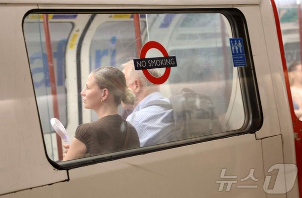 London Commuter Uses Portable Fan to Beat the Heat