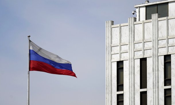 A Russian flag ​is raised on the⁣ grounds ‌of the Russian Embassy⁣ in Washington